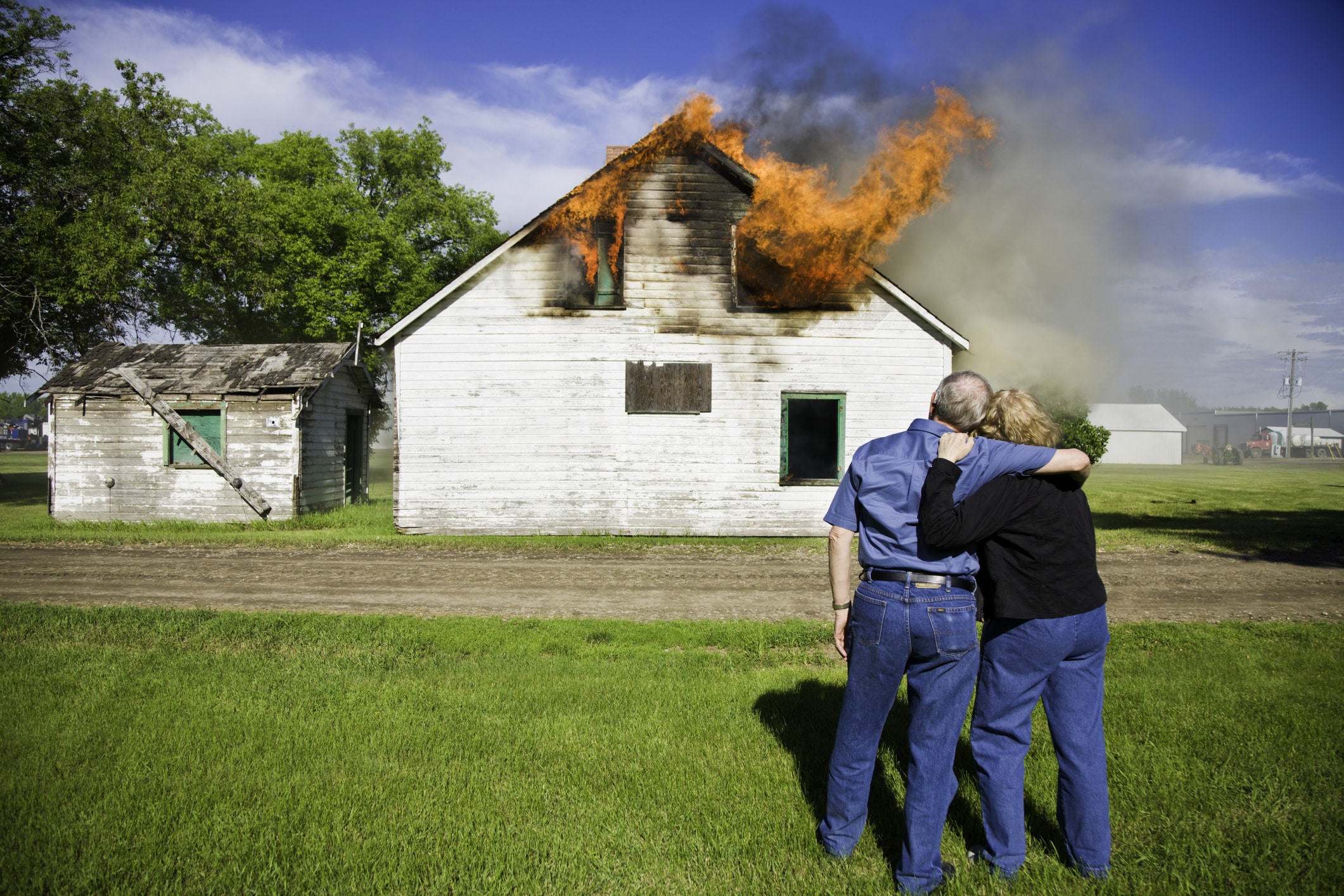 Couple watch as their house is burning to the ground.